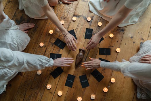 A serene ritual with women in white practicing divination using tarot cards surrounded by candles on a wooden floor.